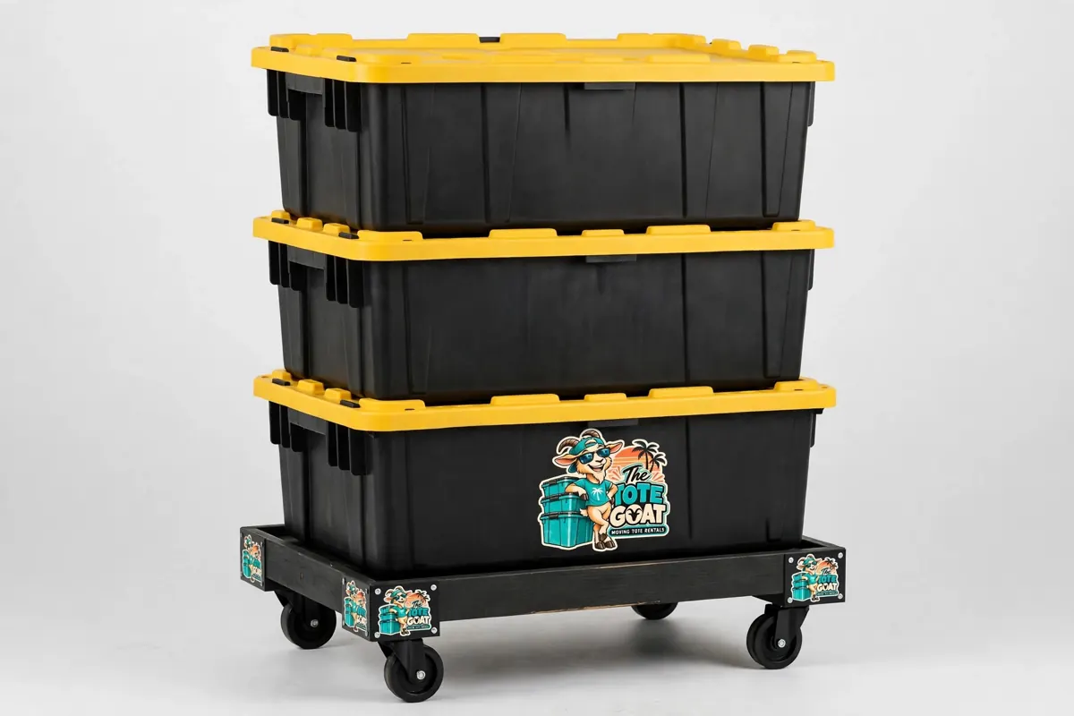 Three black Tote Goat moving totes with yellow lids stacked on a rolling dolly